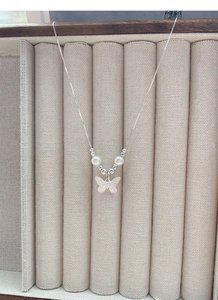Detail of S925 silver necklace with butterfly pendant and white pearls on display