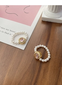 Detail of S925 silver stretch ring with pink gemstone and small white pearls