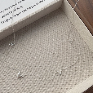 S925 sterling silver necklace featuring multiple heart charms on a delicate link chain