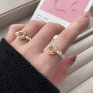 Elegant S925 silver stretch pearl ring featuring a pink gemstone and gold plated finish