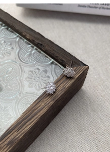 Macro shot of sparkling S925 sterling silver snowflake earrings with cubic zirconia stones