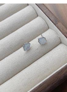 Close-up of S925 silver shell earrings with iridescent mother of pearl in a jewelry box