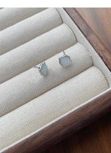 Macro detail of S925 sterling silver shell earrings with natural pearlescent texture