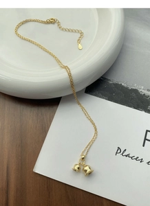 Macro shot of S925 sterling silver lily of the valley necklace with gold plating details