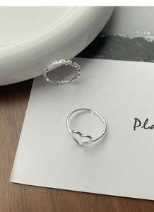 Close-up of S925 sterling silver hollow heart rings with adjustable open band design