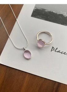 Close-up of S925 silver jewelry set with oval pink quartz necklace and round ring
