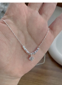 Close-up of S925 sterling silver necklace featuring a sparkling round solitaire pendant