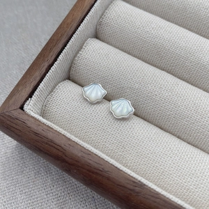 Elegant S925 sterling silver shell stud earrings displayed in a wooden jewelry box