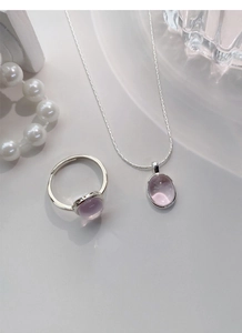 Detail of pink oval gemstone ring and matching necklace set in polished S925 silver