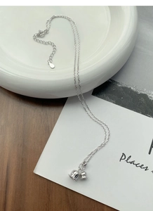 Macro detail of S925 sterling silver lily of the valley necklace with bell pendants