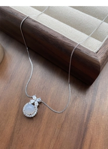 Macro detail of S925 sterling silver bow necklace with lavender chalcedony and diamonds