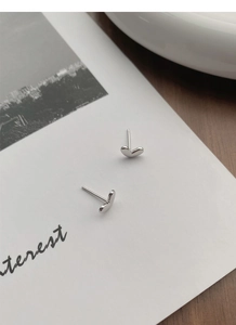 Detail shot of heart-shaped S925 sterling silver stud earrings on artistic card