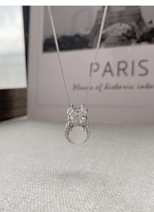 Macro shot of S925 silver necklace with chalcedony bow pendant and sparkling crystals