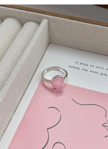 Close-up of a pink oval gemstone ring on a S925 sterling silver adjustable band