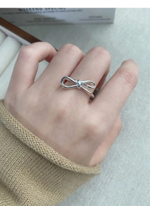 Detailed macro view of S925 sterling silver bow ring featuring smooth polished finish