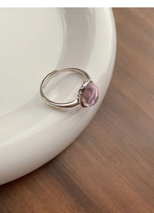 Macro shot of S925 sterling silver stamp on minimalist pink gemstone open ring