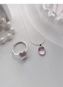 Detailed view of S925 sterling silver necklace and ring set with oval pink gemstones