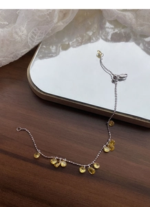 Detail of S925 silver adjustable bracelet with yellow teardrop zircon charms