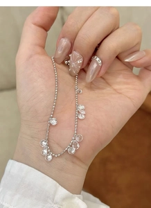 Detail of S925 silver beaded bracelet featuring sparkling clear faceted crystal charms