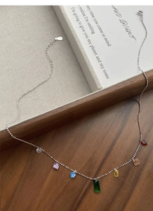 Detail of S925 sterling silver necklace with seven colorful zircon gemstone charms