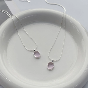 Elegant S925 sterling silver necklace with oval pink crystal pendant in a white dish