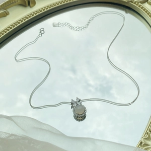 Elegant S925 silver necklace with white chalcedony pendant on reflective mirror surface