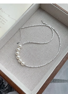 Close-up of S925 silver necklace with faceted beads and six natural pearls in a box