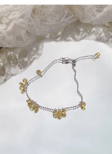 Detail of S925 silver double-layered bead bracelet with yellow teardrop stones and slider