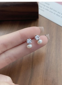 Close-up of S925 silver stud earrings with square cubic zirconia and white freshwater pearl