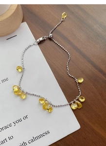 Close-up of S925 sterling silver bead bracelet with yellow pear-cut zircon and adjustable slider