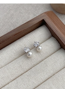 Close-up of S925 silver stud earrings with square zircon and white freshwater pearl