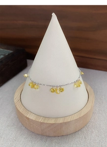 Detailed close-up of S925 silver beaded bracelet with sparkling yellow zircon charms