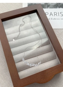 Macro shot of S925 sterling silver wisteria necklace with pear-cut zircon pendants