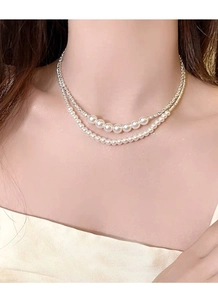Detail of elegant double-layer S925 silver necklace with gradient pearls on model