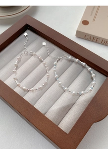 Close-up of S925 silver beaded bracelets with freshwater pearls and blue aquamarine stones