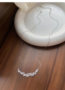 Detail view of S925 sterling silver wisteria necklace with pear-shaped stones on white tray