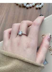 Macro shot of S925 sterling silver ring with radiant rectangular zircon on model's finger