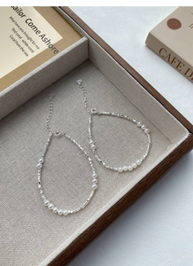 Detailed macro view of S925 sterling silver pearl bracelet on beige jewelry box lining