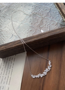Macro detail of S925 sterling silver stamp and sparkling zircon wisteria necklace