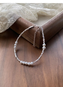 Macro view of S925 sterling silver beads and pearls bracelet with a heart-shaped tag