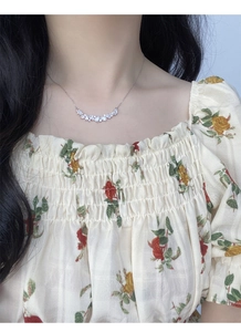 Close-up of S925 silver necklace with marquise and pear-shaped white zircons on a model