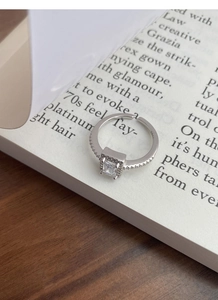 Macro shot of S925 sterling silver stamp and sparkling rectangular zircon on open ring