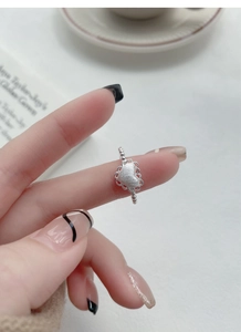 Detail of S925 silver beaded heart ring with matte texture and intricate lace edge