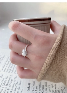 Close-up of S925 silver matte heart ring with delicate lace edge on finger