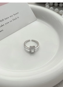Macro shot of S925 sterling silver square zircon ring with engraved hallmark on inner band