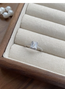 Macro view of rectangular zircon halo setting and pave stones on silver ring band