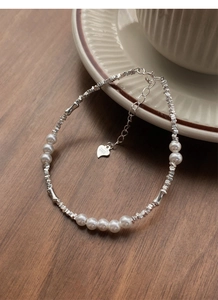 Detail of S925 sterling silver beads and pearls bracelet with a small heart charm