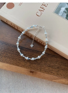 Detail of S925 silver bracelet with freshwater pearls and light blue gemstone beads