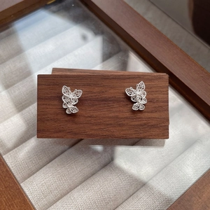 S925 sterling silver butterfly stud earrings with hollow filigree on walnut wood stand
