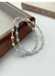 Detail of S925 silver bracelet with freshwater pearls and blue aquamarine stones